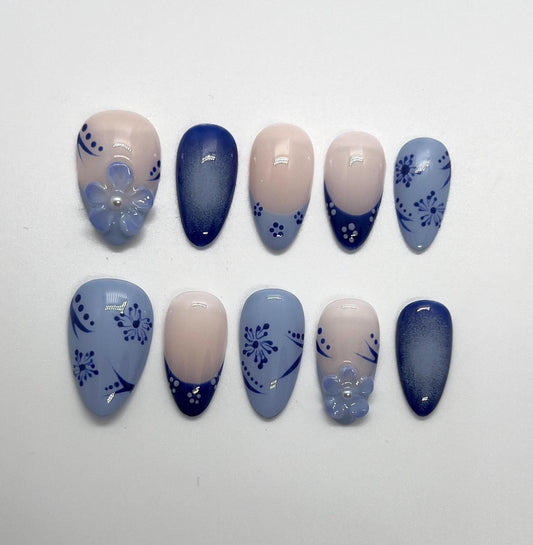 Handmade blue and beige press-on nails with Blue Floral Bloom design on a white background