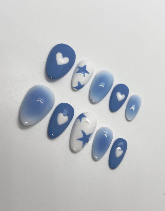 Step into a dreamy, futuristic glow with the Blue Lunar Chrome handmade press-on nail set, featuring soft lunar-blue gradients and reflective silver chrome details. This stunning design showcases abstract molten chrome patterns and delicate star accents that shimmer like moonlight, perfect for anyone who loves bold, celestial-inspired nails with a modern edge.