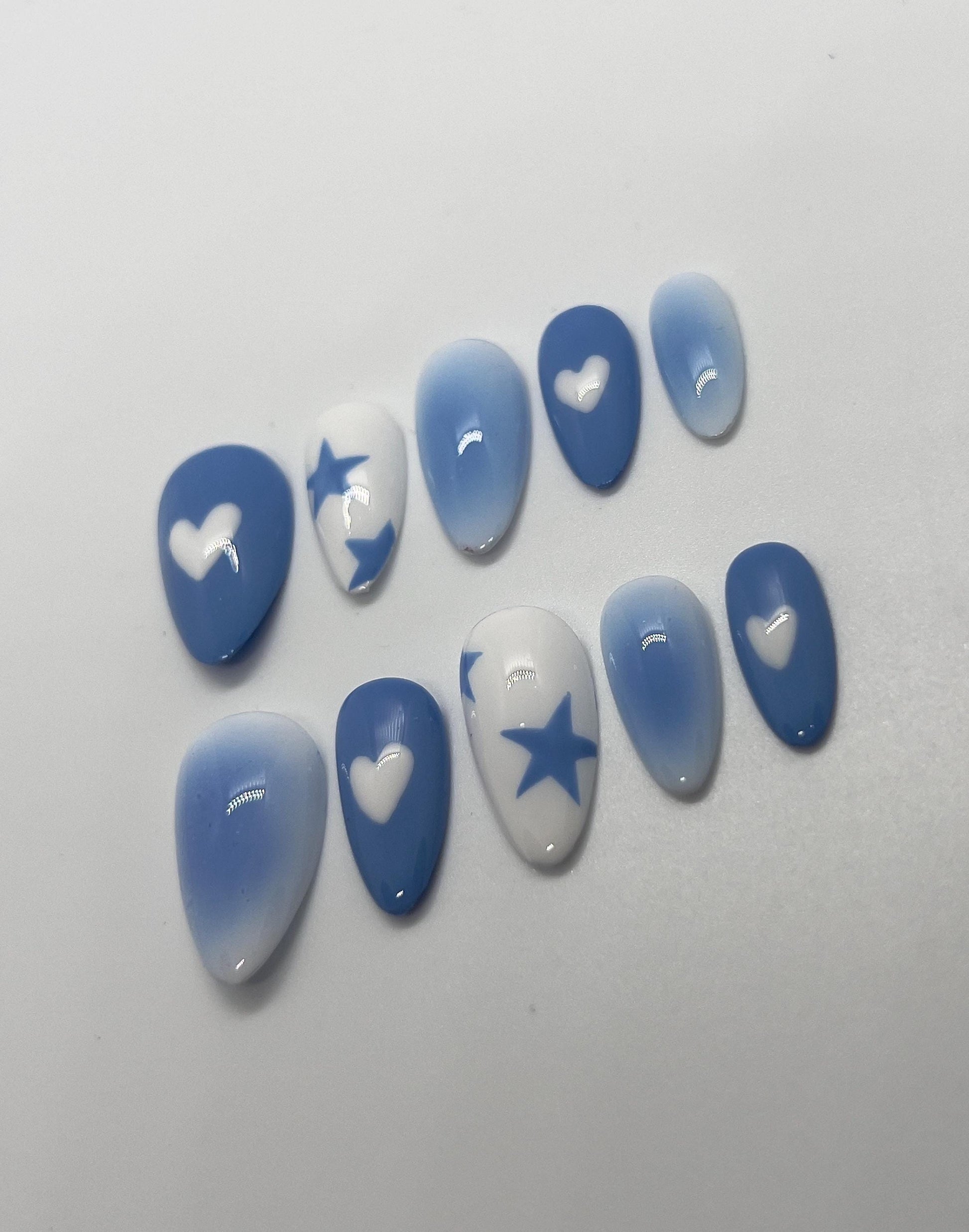 Step into a dreamy, futuristic glow with the Blue Lunar Chrome handmade press-on nail set, featuring soft lunar-blue gradients and reflective silver chrome details. This stunning design showcases abstract molten chrome patterns and delicate star accents that shimmer like moonlight, perfect for anyone who loves bold, celestial-inspired nails with a modern edge.