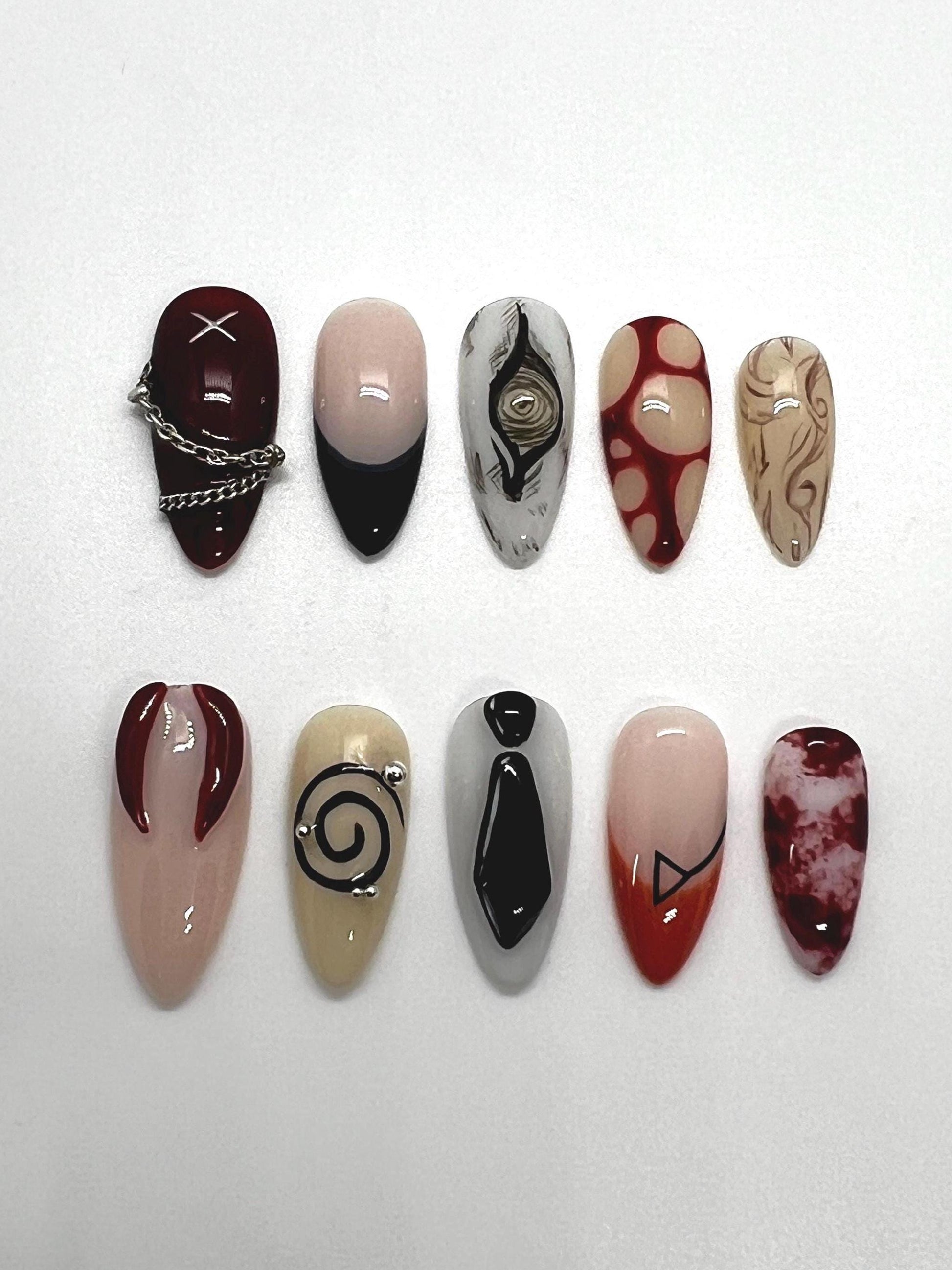 Handmade artistic press-on nails featuring Devil Contract and Chainsaw Man-themed designs on a white background