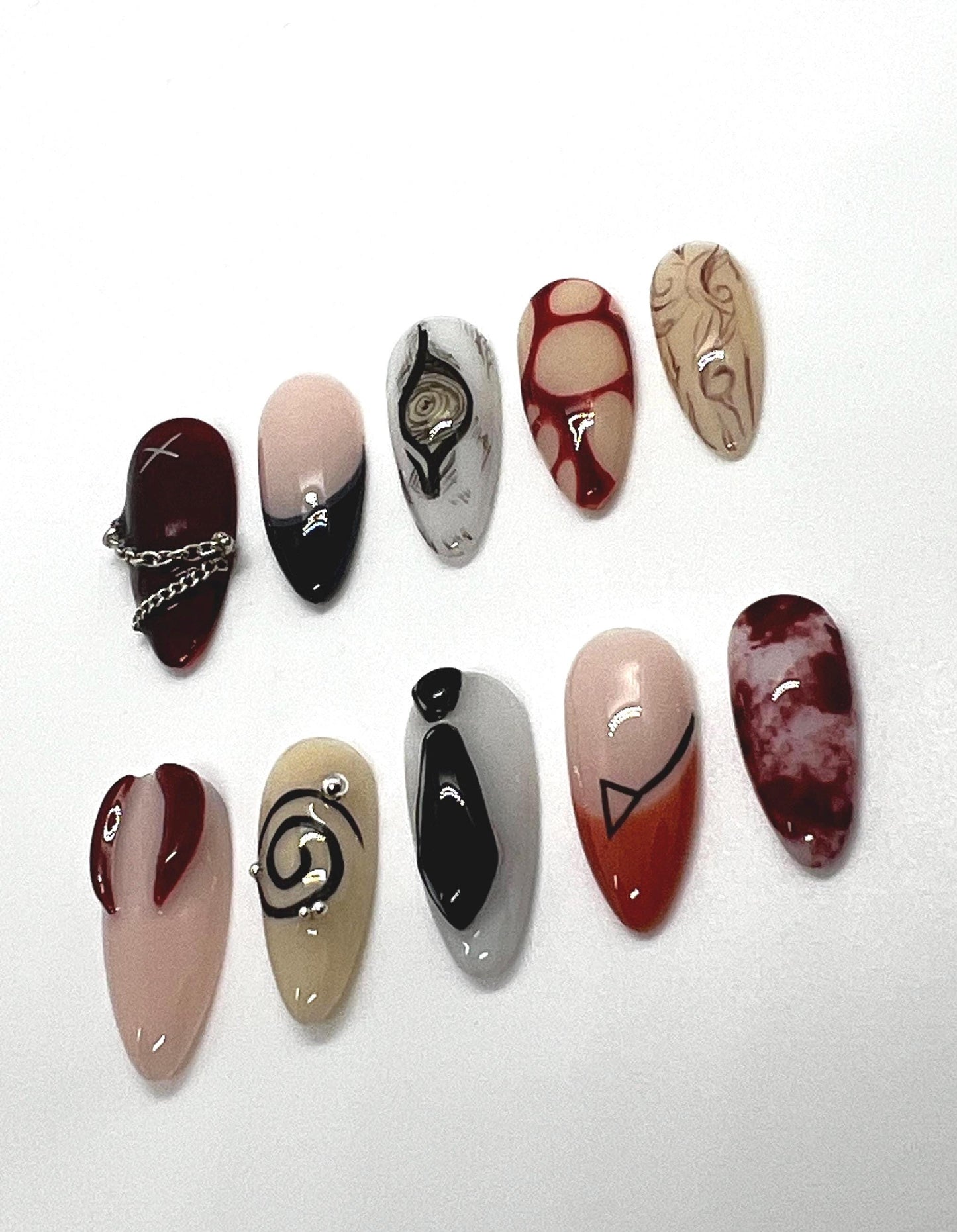 Handmade artistic press-on nails featuring Devil Contract and Chainsaw Man-themed designs on a white background