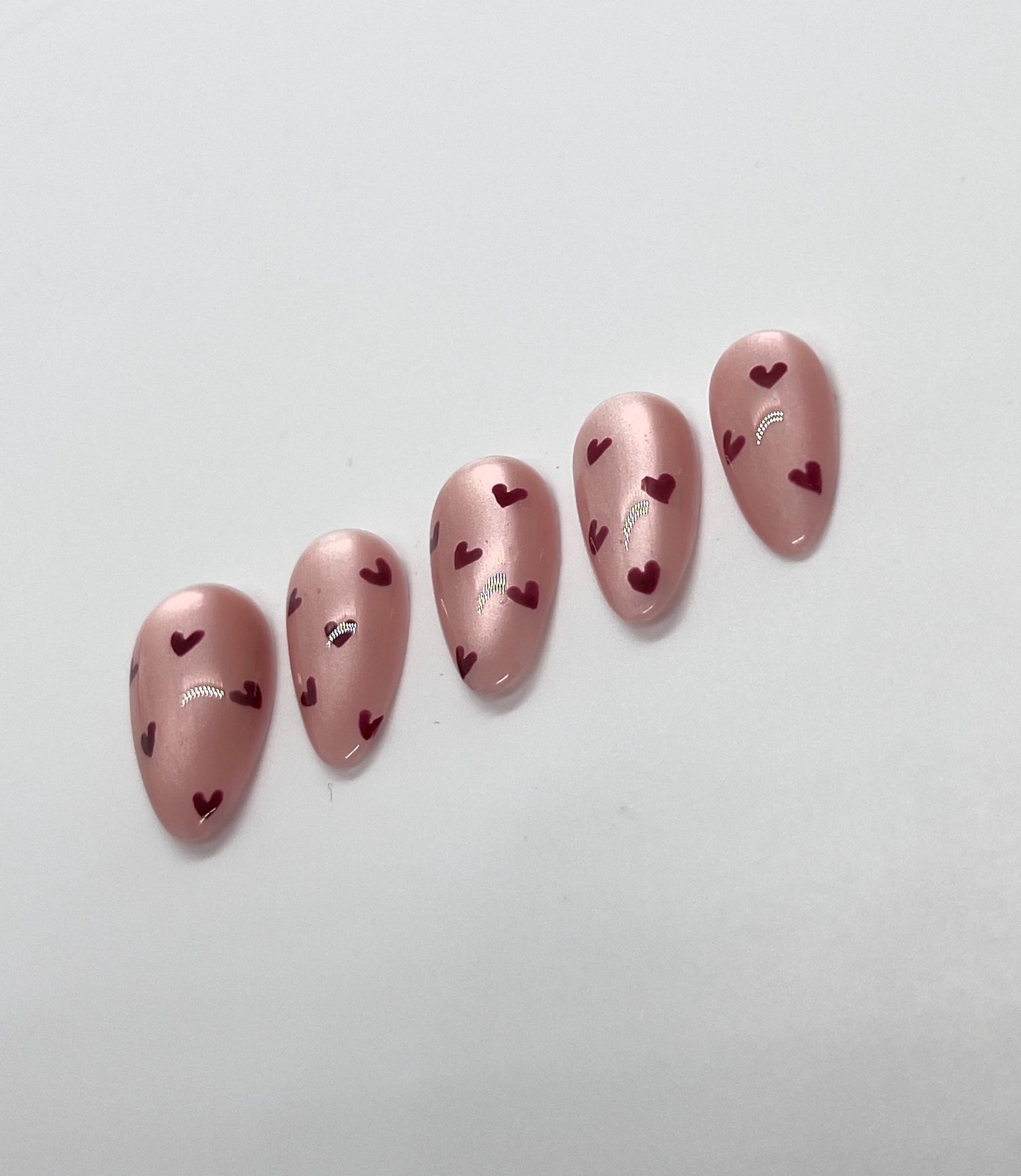 Embrace the season of love with this handmade press-on nail set, featuring soft pinks, romantic reds, and delicate accents that capture the spirit of Valentine’s Day. Perfect for adding a touch of sweetness and elegance to any look—whether it’s a date night, celebration with friends, or simply treating yourself.