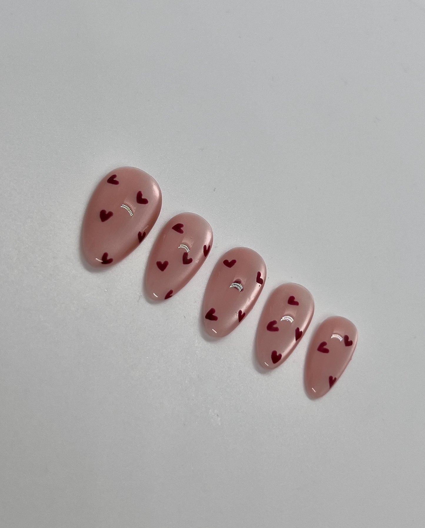Embrace the season of love with this handmade press-on nail set, featuring soft pinks, romantic reds, and delicate accents that capture the spirit of Valentine’s Day. Perfect for adding a touch of sweetness and elegance to any look—whether it’s a date night, celebration with friends, or simply treating yourself.