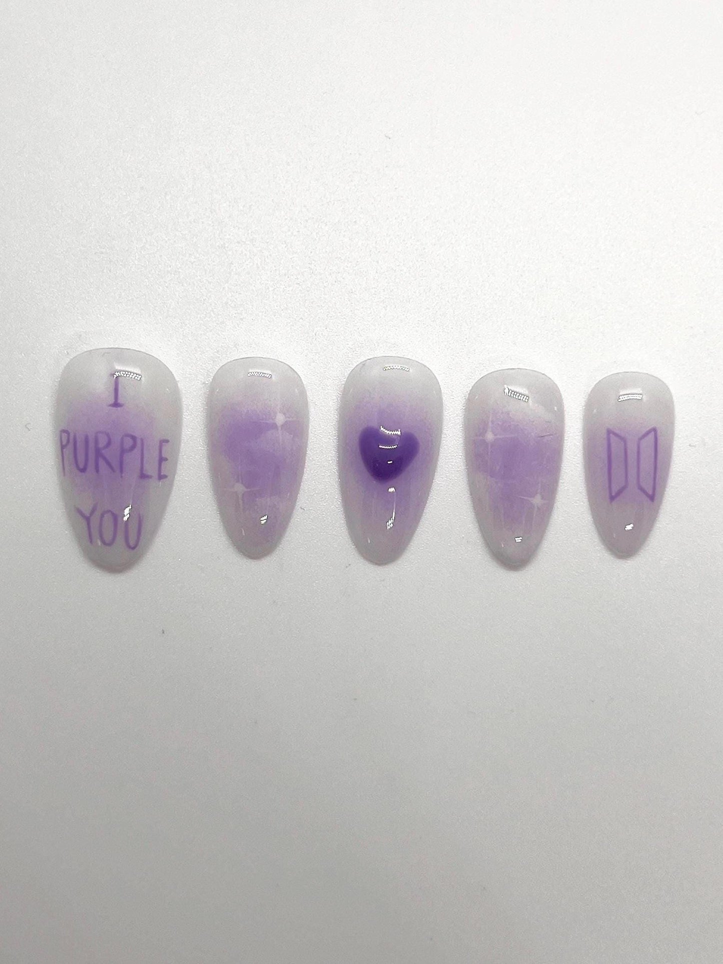 This BTS-inspired handmade press-on nail set features purple and white gradient tones with elegant detailing, inspired by BTS’s signature purple. Designed to represent love, trust, and the lasting bond between artist and fans, these nails are perfect for ARMYs who want a subtle yet meaningful look.