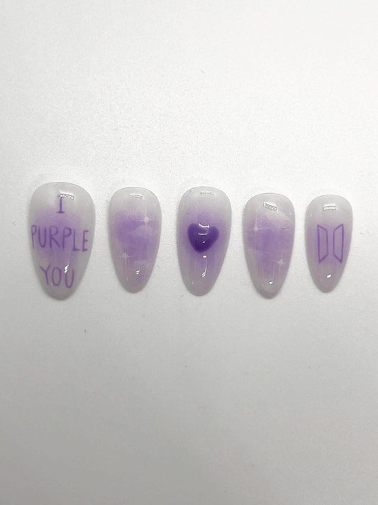 This BTS-inspired handmade press-on nail set features purple and white gradient tones with elegant detailing, inspired by BTS’s signature purple. Designed to represent love, trust, and the lasting bond between artist and fans, these nails are perfect for ARMYs who want a subtle yet meaningful look.