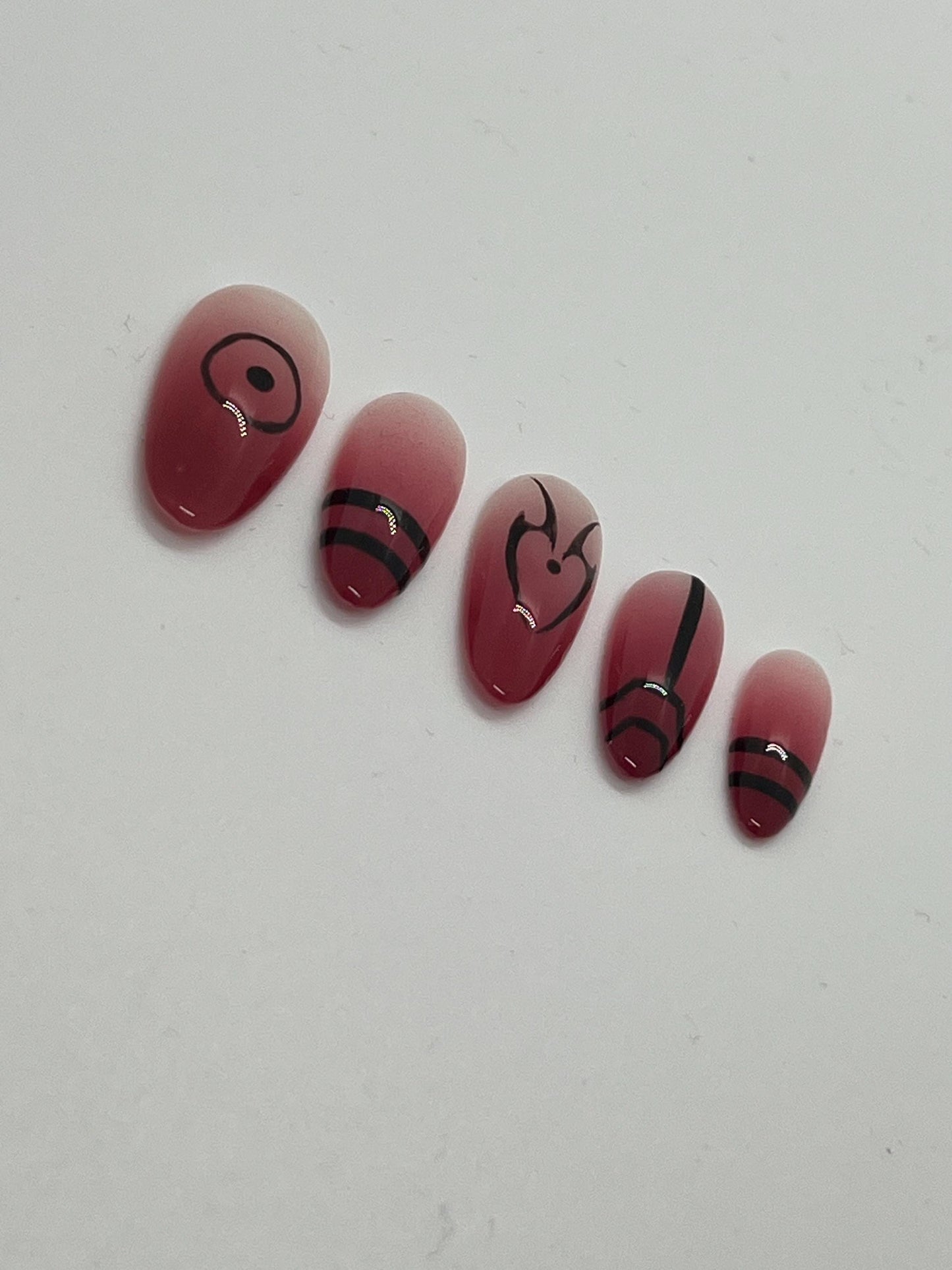 This Ryomen Sukuna-inspired handmade press-on nail set draws inspiration from the powerful and sinister energy of Jujutsu Kaisen. Featuring a red ombré base with bold black accents and intricate curse mark–style designs, each set perfectly captures Sukuna’s dark and regal aesthetic.

Each set includes five unique nail designs that mirror Sukuna’s distinct markings, making it ideal for anime fans, cosplay, or anyone looking to add a bold, mysterious edge to their look.