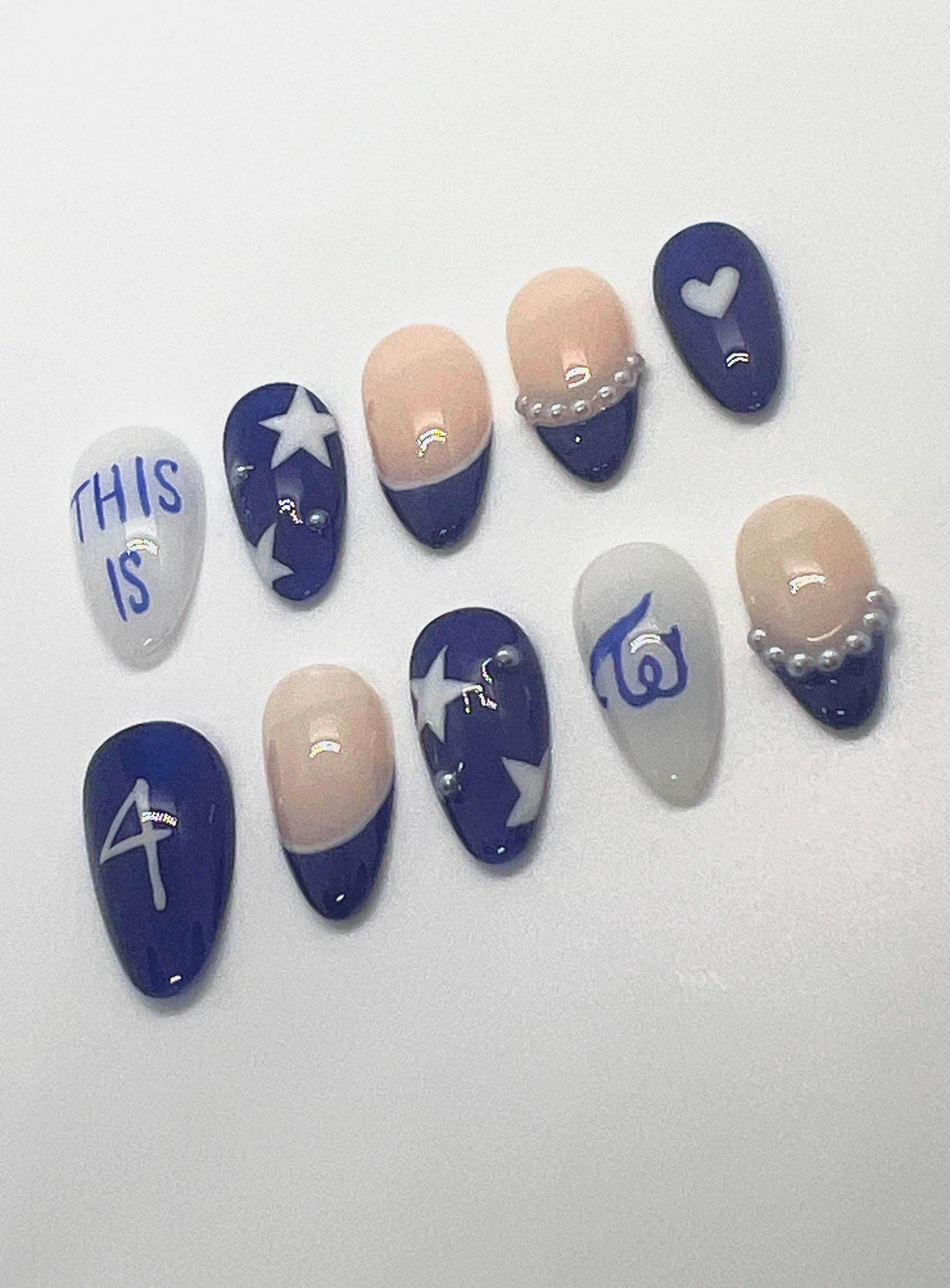 This TWICE-inspired handmade press-on nail set blends soft glam with playful charm, reflecting the group’s signature elegance and confidence. Featuring blue and beige tones with delicate details and polished finishes, these nails capture the essence of TWICE’s iconic stage presence.